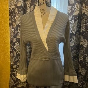 Long-sleeved business casual or dressy sweater, gray color with white trimmings.